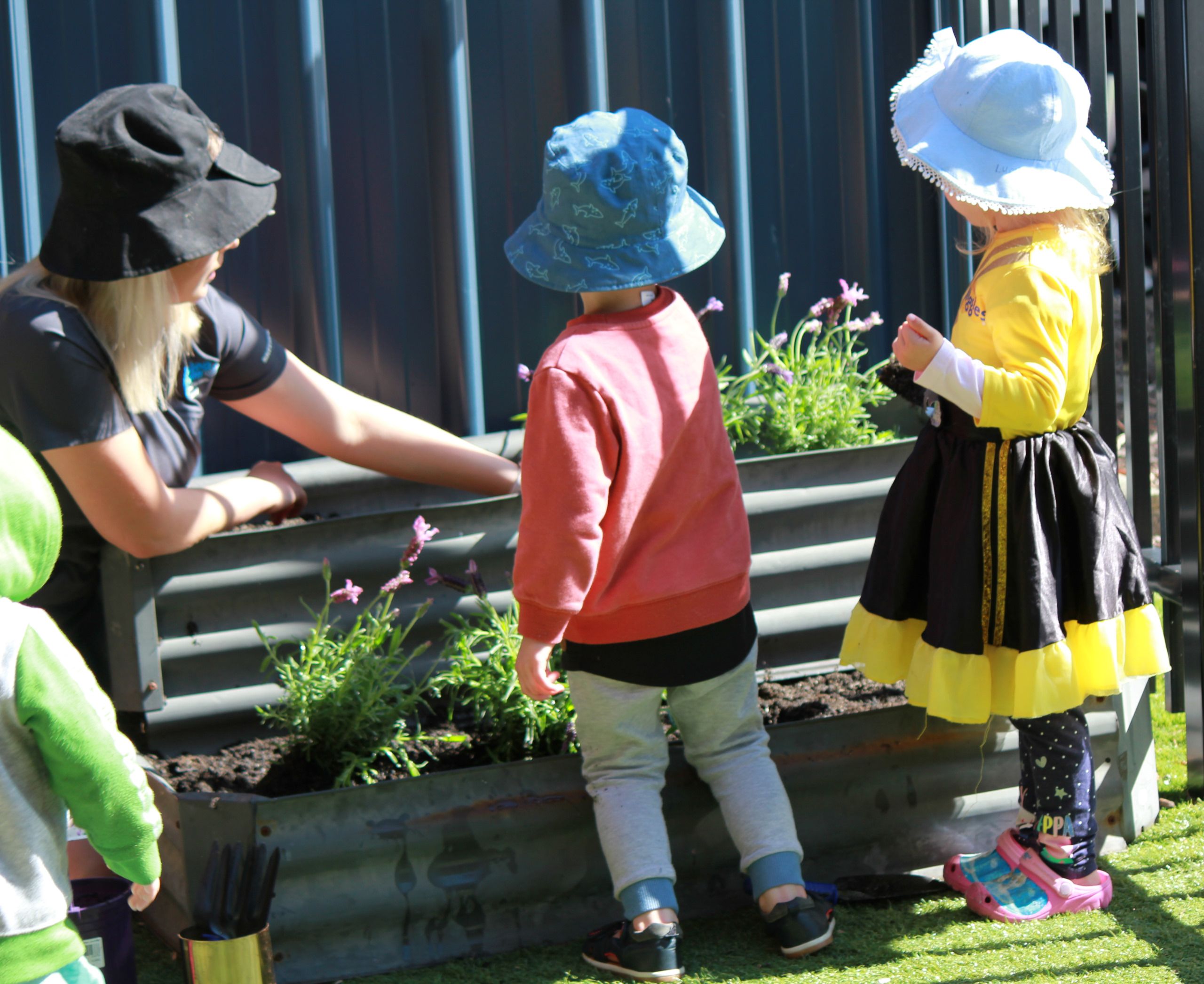 Educator and kids gardening