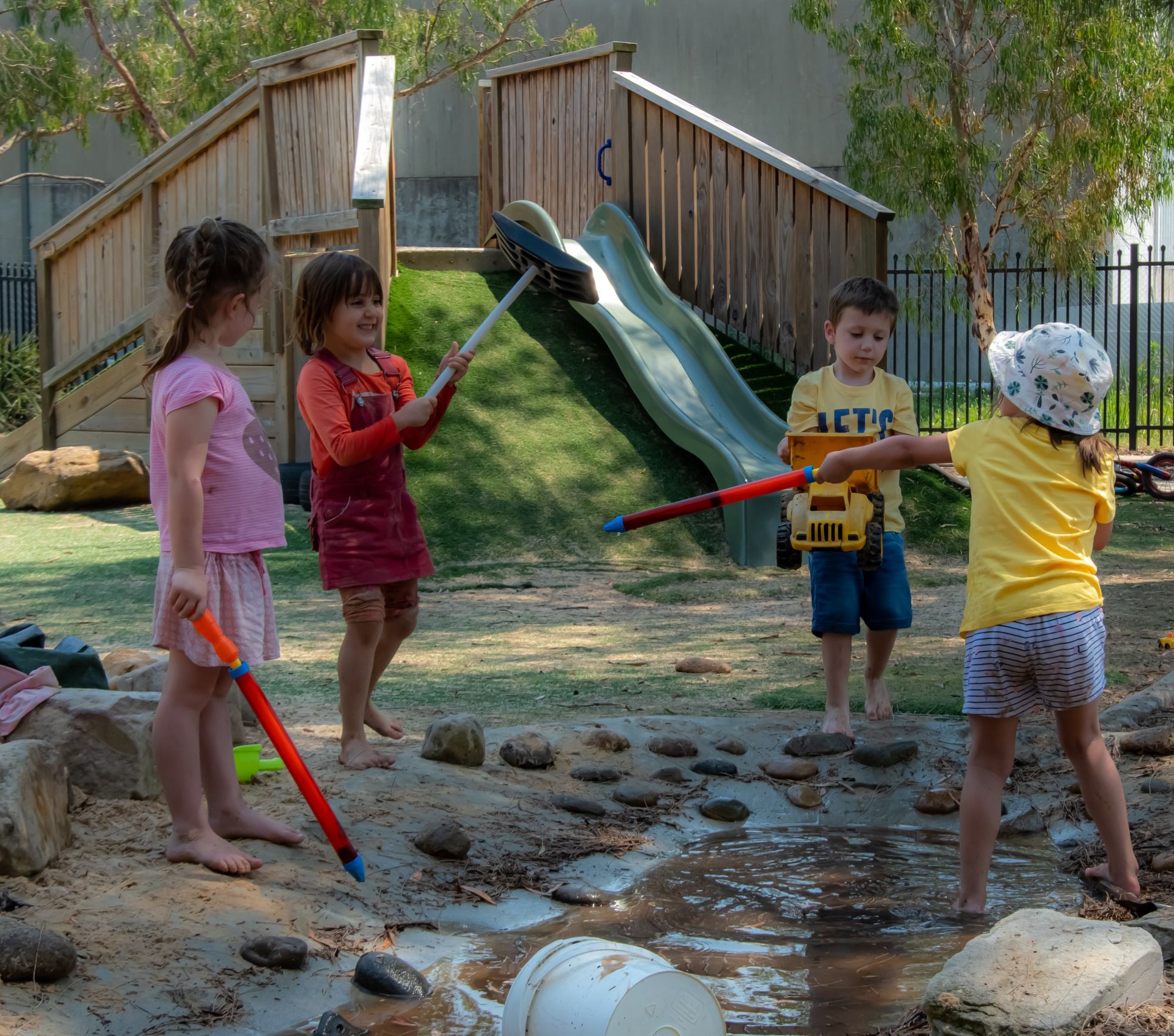 Four kids playing in daycare playground